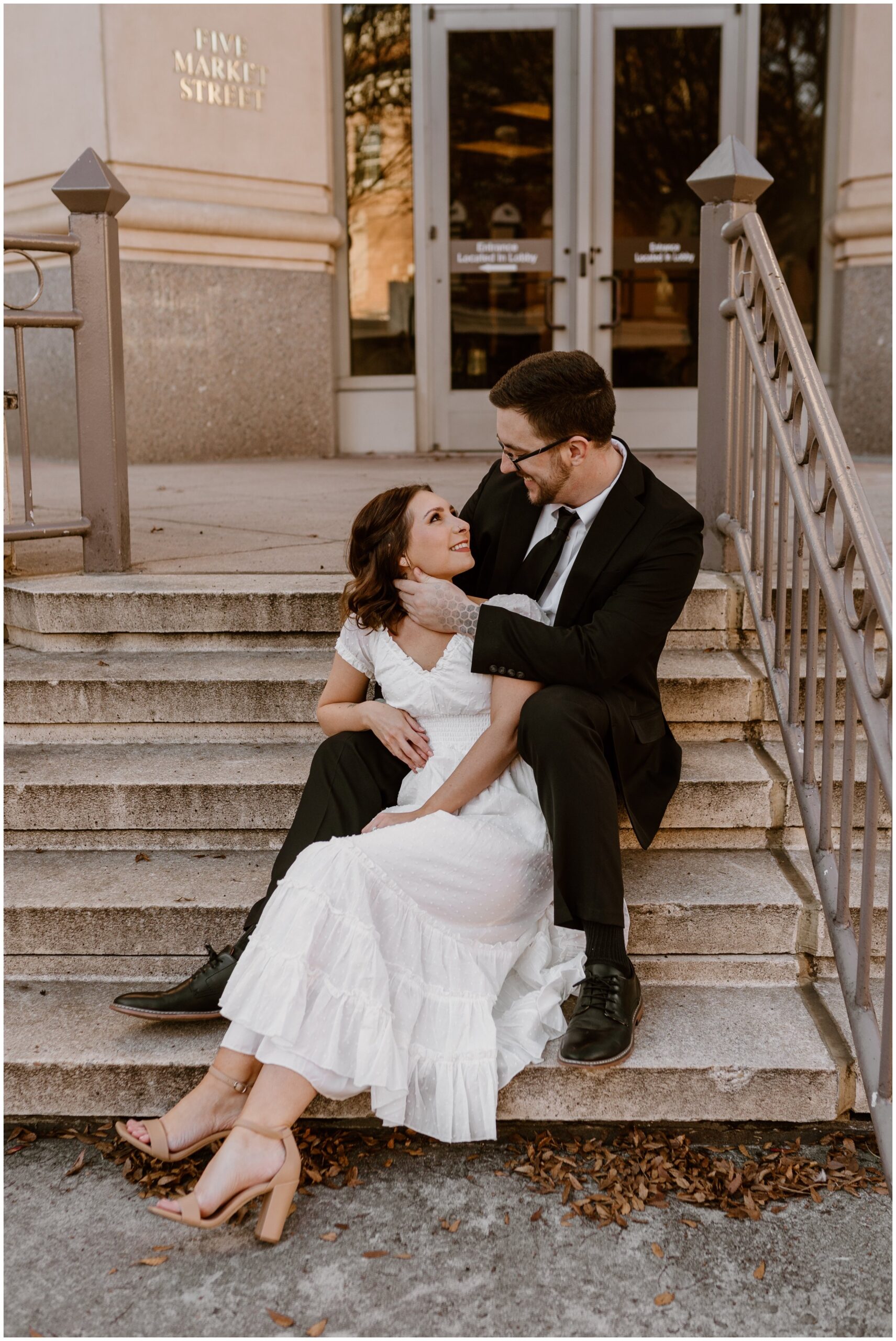  Couple sitting on stairs together in Downtown Roanoke 