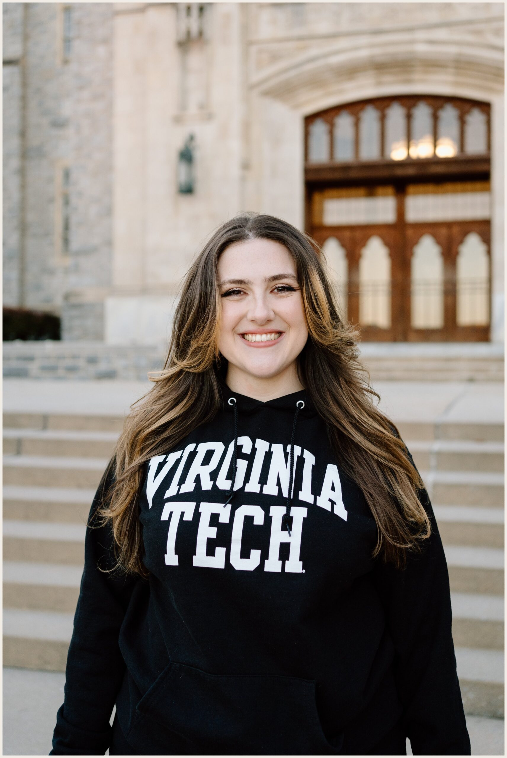 Virginia Tech graduation portrait of a woman at Burruss Hall